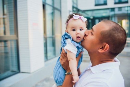 father kissing daughter