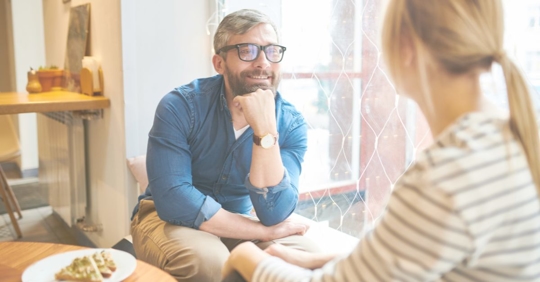 a happy man talking to a woman