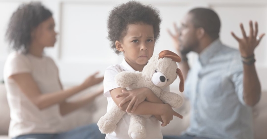 parents arguing behind child