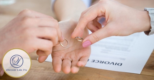 Man and woman putting wedding rings into the hand of a lawyer