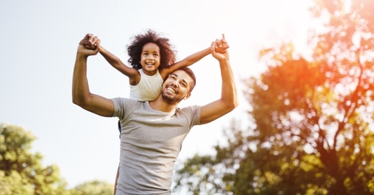 African American Dad with his daughter on his shoulders