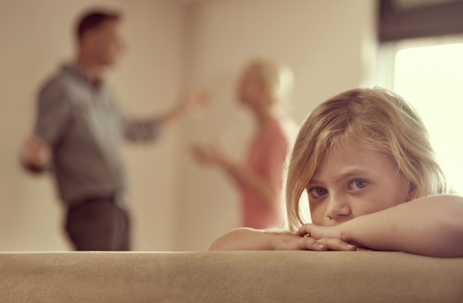 a child looking on as parents argue